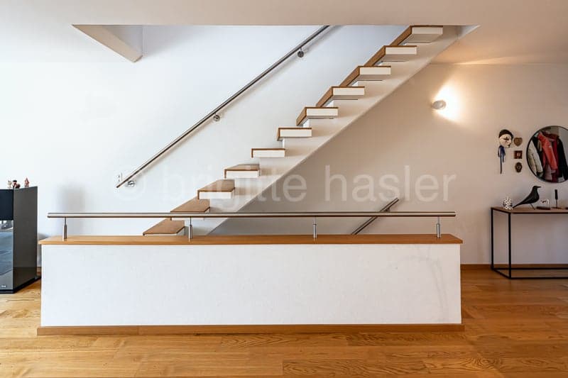 wooden staircase, metal handrail, white walls, wooden floor, modern design
