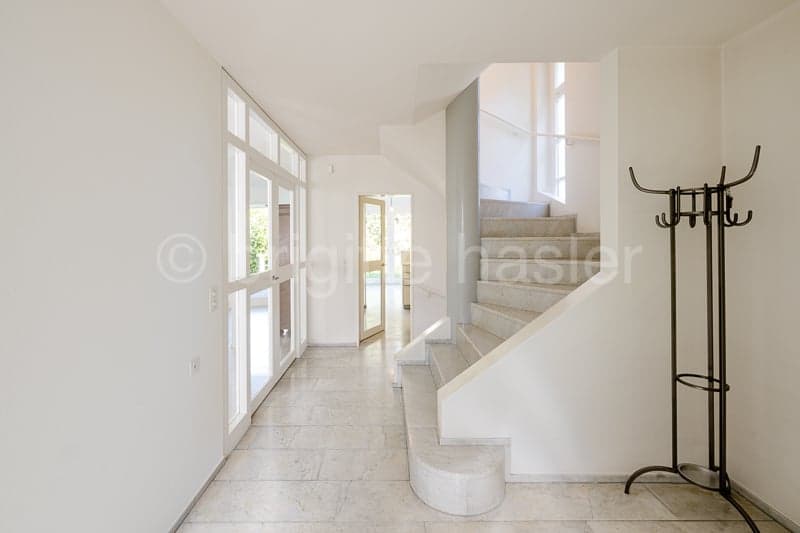 white walls, white tiled floor, white staircase, glass doors, hallway