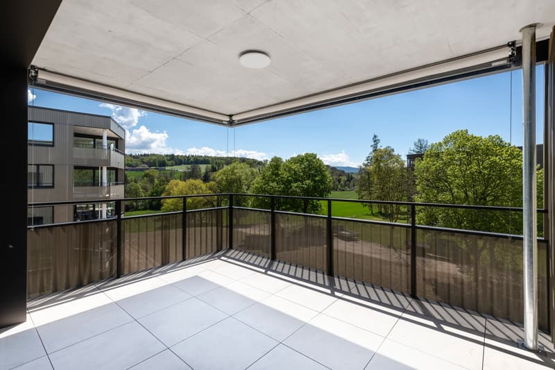 Modern balcony with white tiled floor, glass and metal railings, unobstructed view