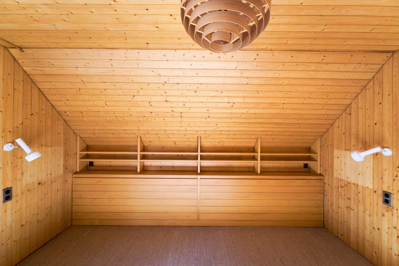 Wooden interior with shelves, wooden ceiling, and a decorative light fixture