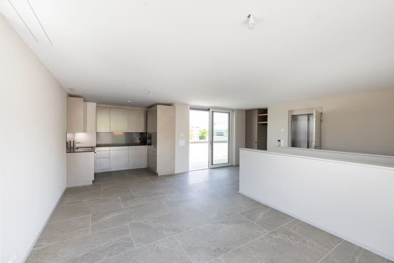 Open kitchen with countertops, built-in appliances, sliding glass doors to balcony