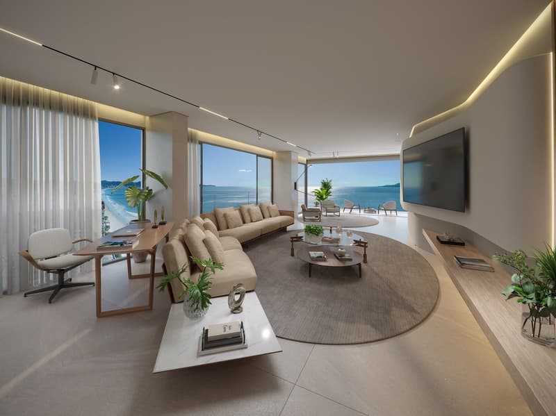 modern living room with large windows, beige sofa, round coffee tables, wooden desk, white chair, large flat screen TV, plants, ocean view