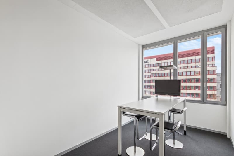 empty room, white walls, white desk, 2 stools, large window, monitor, lamp