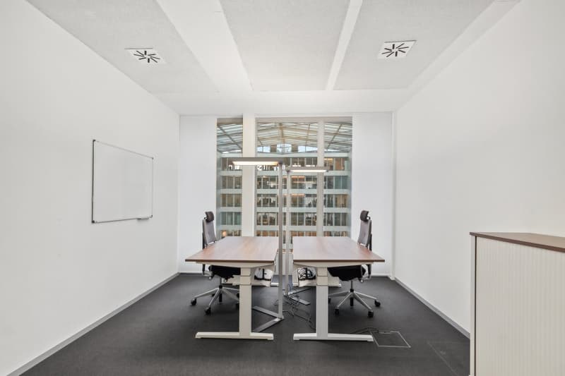 empty room, two desks, two chairs, whiteboard, large windows