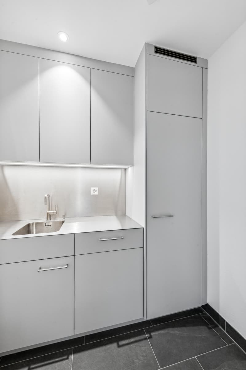 modern kitchen with stainless steel sink, faucet, cabinets, and tiled floor