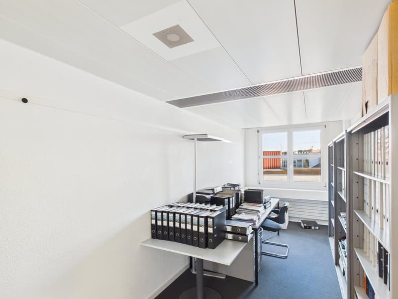 empty office room, desk, filing cabinets, bookshelves, floor lamp, carpeted floor