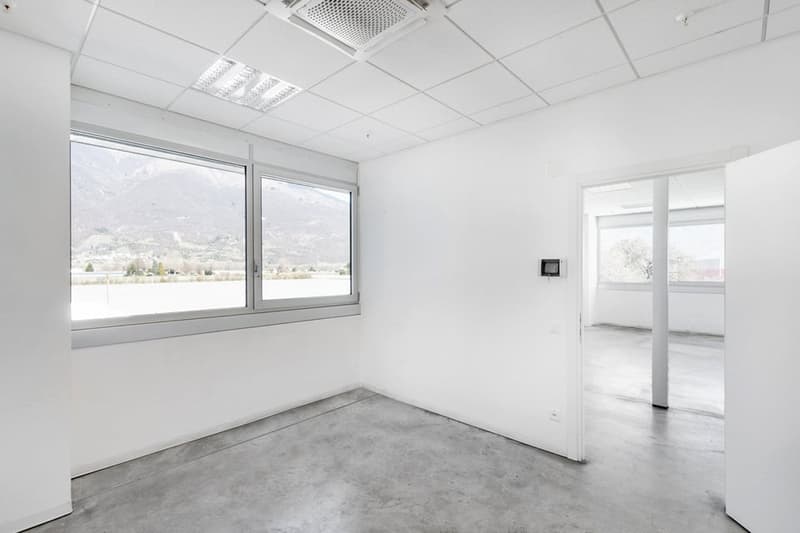 modern office room, clean walls, gray floor, large windows, mountain view