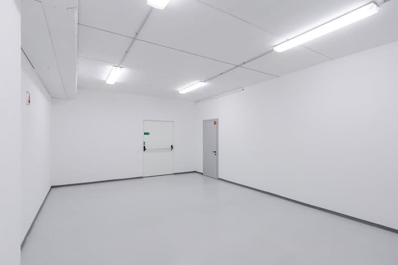 empty room, white walls, white floor, ceiling lights, double doors