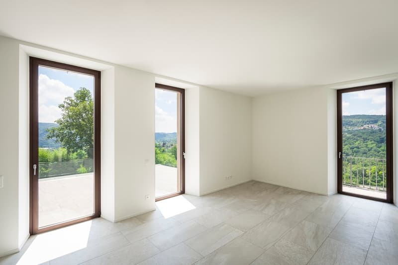 large glass doors, balcony, tile flooring, white walls, balcony railings, views of green landscape