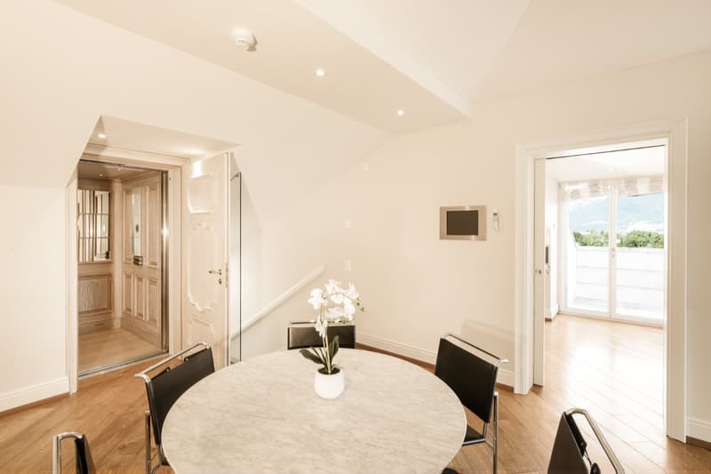 modern interior, round table, marble table top, black chairs, flower in a vase, hardwood floor, glass doors