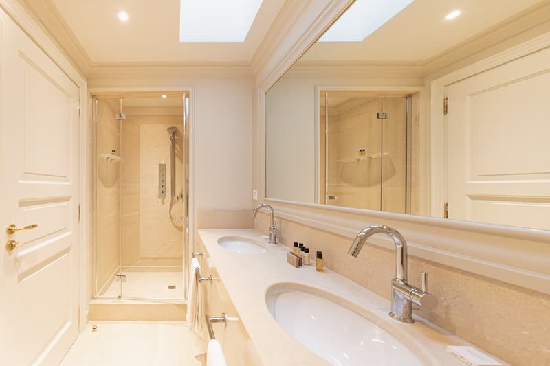 Bathroom: modern design, walk-in shower, vanity with double sinks, mirror with marble frame, towels on rack