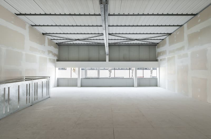 Empty room, white walls, white ceiling, white floor, metal railings, large windows