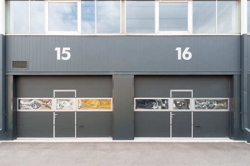 Two garage doors, each with three windows, labeled 15 and 16