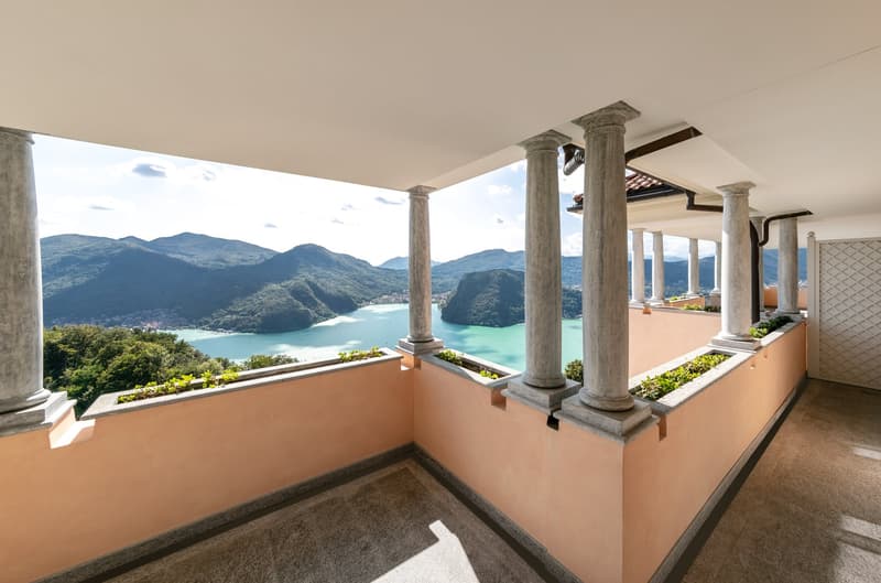 balcony with lake view, columns, plants, tiled floor