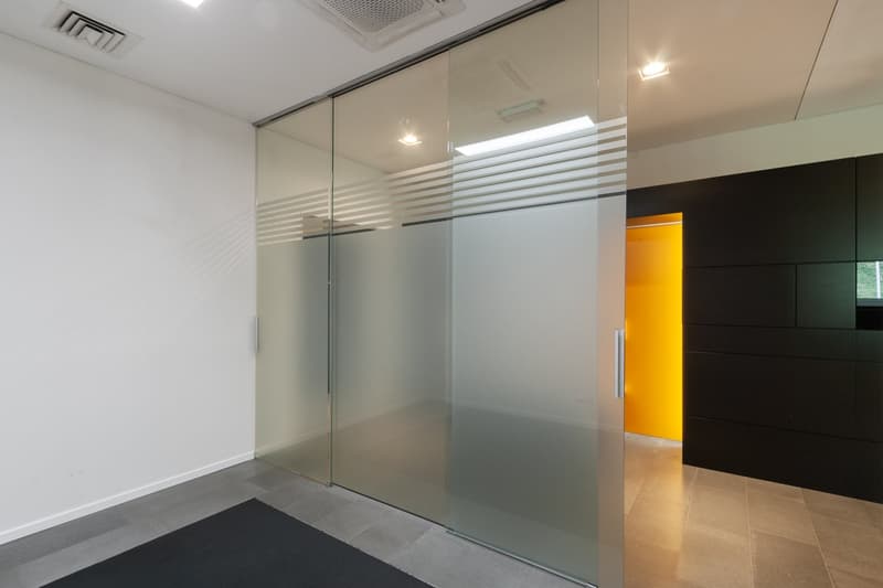 empty room, glass walls, white walls, black floor, yellow door