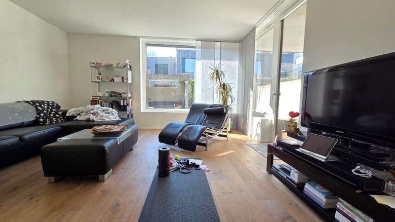 modern living room, black leather sofa, coffee table, TV, entertainment center, floor to ceiling windows