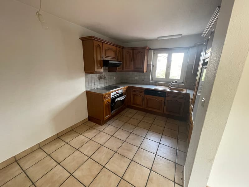wooden cabinets, tiled floor, gas stove, oven, sink, dishwasher, window
