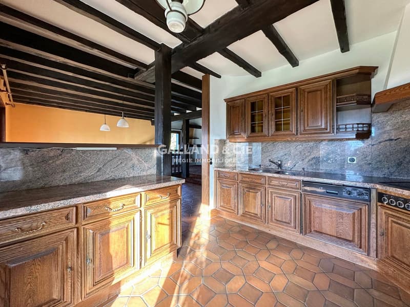 wooden cabinets, marble countertops, granite backsplash, sink, dishwasher, wooden beams