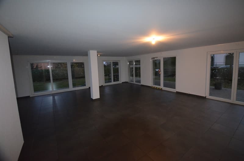 large room, tiled floor, high ceiling, sliding doors, white walls, large windows