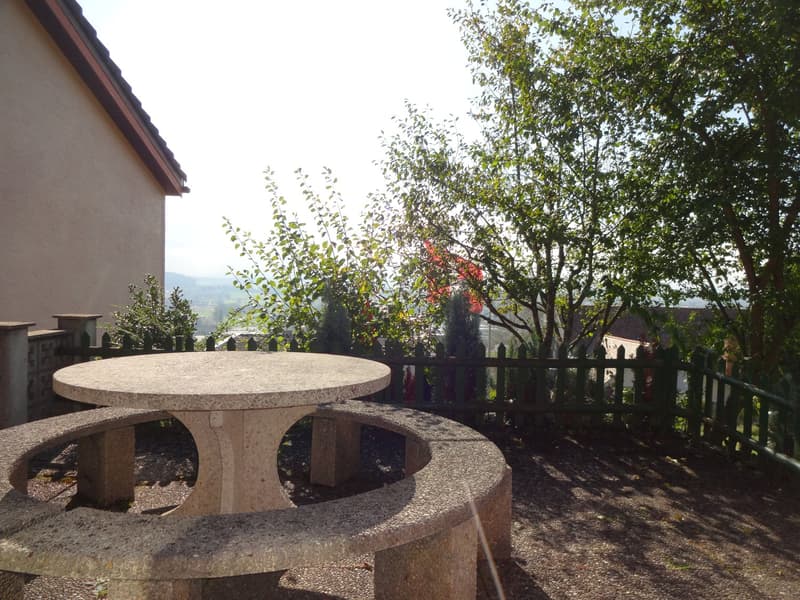 stone bench, stone table, fence, trees, distant mountains