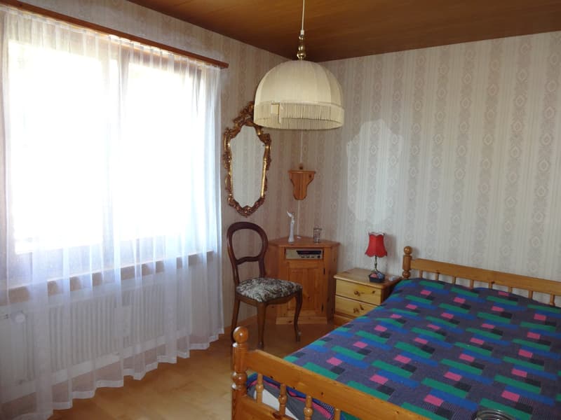 wood floor, white wall, wooden bed, lamp, wooden chair, wooden nightstand, mirror, wooden cabinet, lamp, glass, white curtains