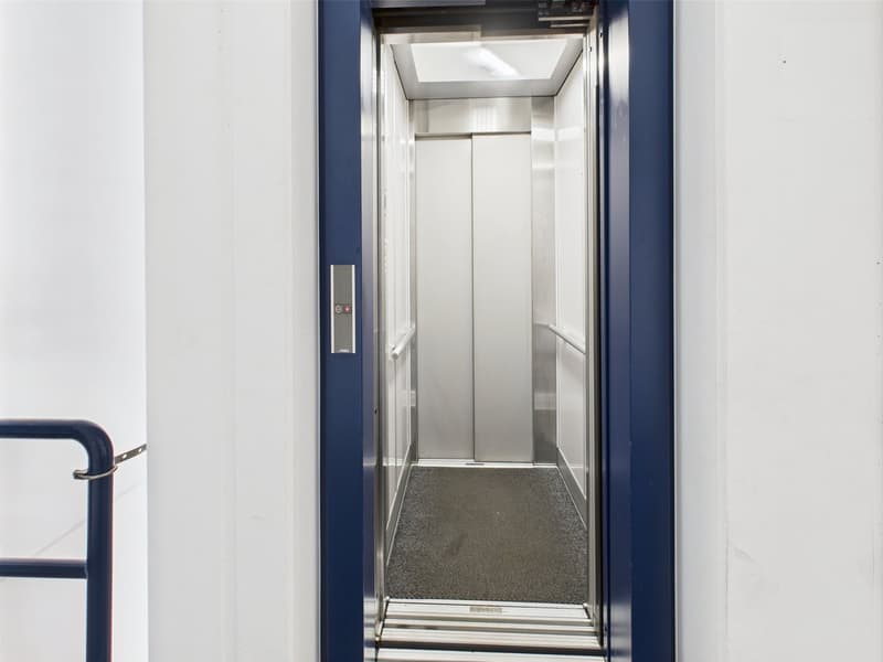 modern stainless steel elevator, white interior, blue exterior