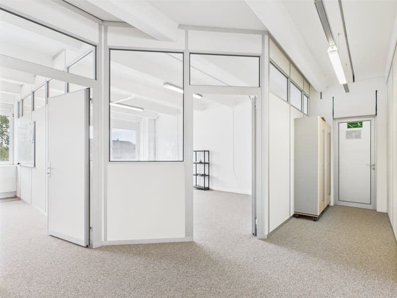 office room, modern design, white walls, large windows, glass panels, carpeted floor, open layout, ceiling lights