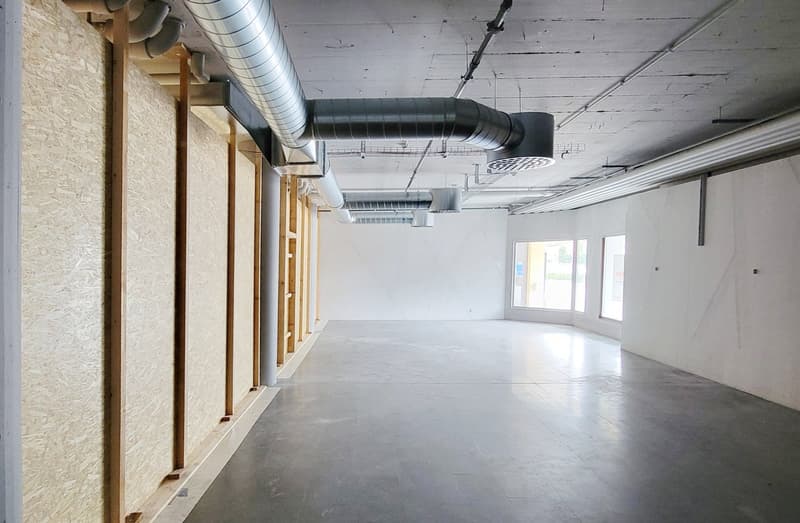 concrete floor, white walls, steel pipes, no furniture