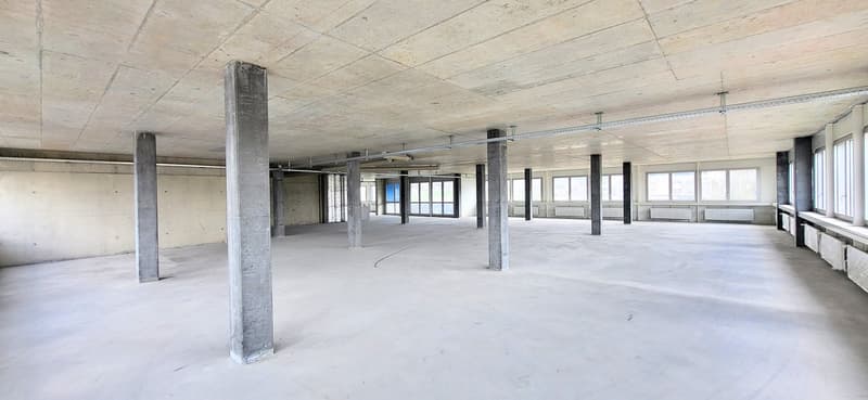 concrete floor, beams and pillars, windows, heaters on the wall