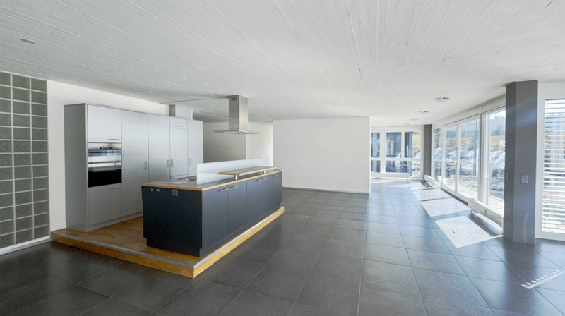 modern kitchen with island, large windows, tiled floor, stainless steel appliances