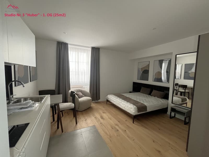 Small studio with bed, seating area, kitchen, and bathroom.