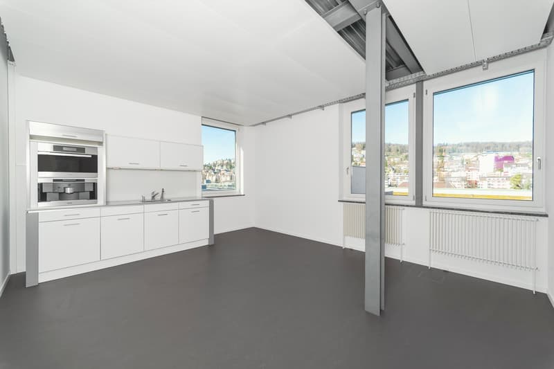 Modern white kitchen with stainless steel appliances, large windows, modern interior