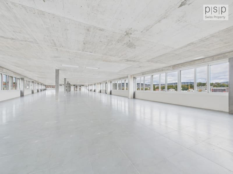 An empty corridor with large windows, white walls and ceilings, and tiled flooring