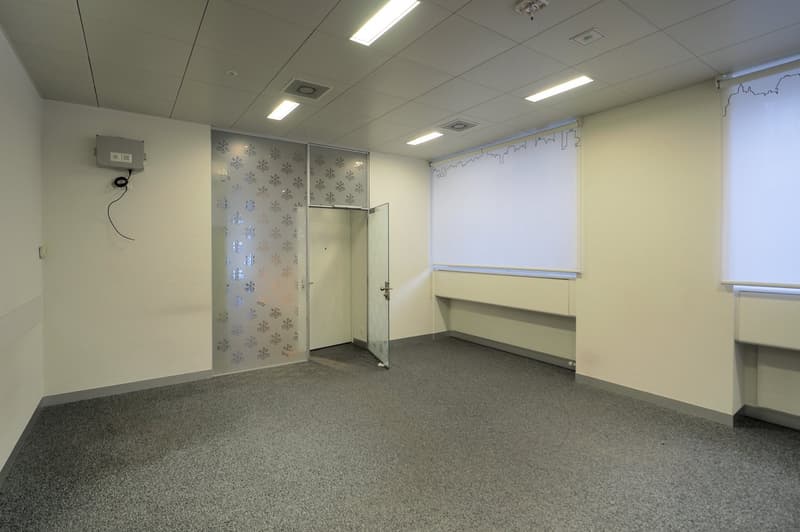 white walls, ceiling lights, glass door, floor