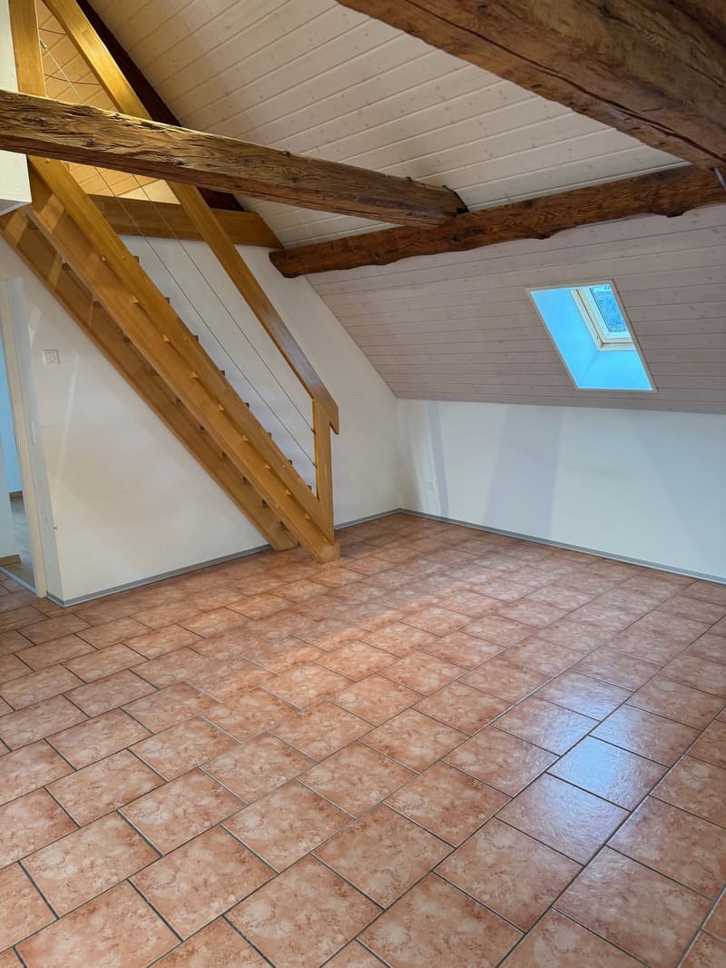 empty room, wooden beams, tiled floor, wooden staircase, skylight