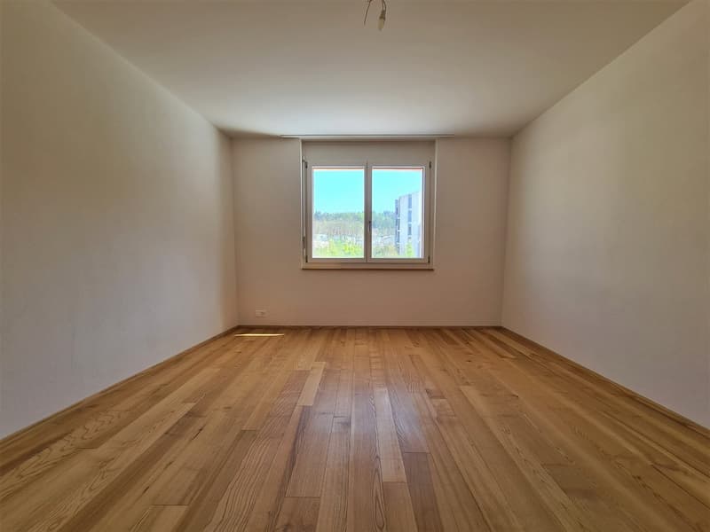 large window, wooden floor, white walls
