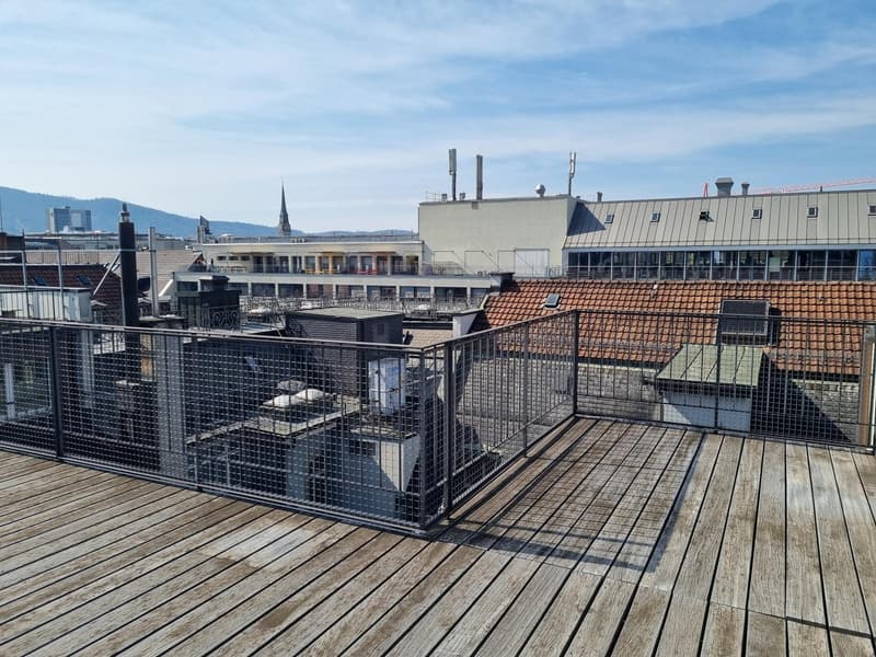 Wooden deck, metal railing, view of the city