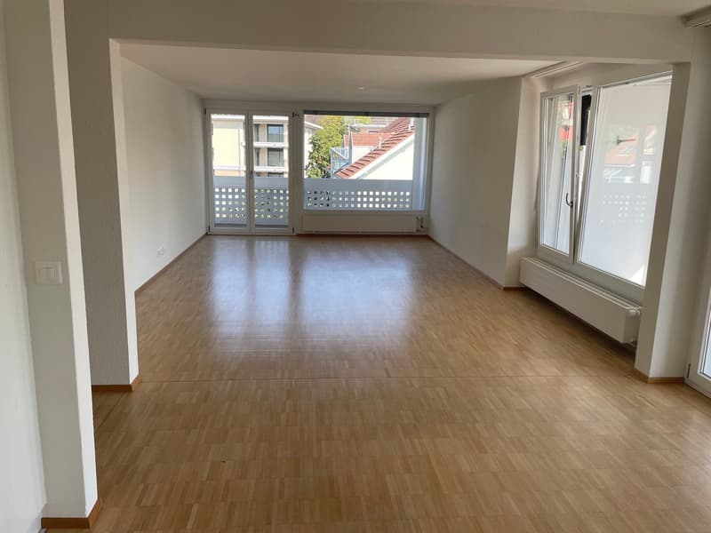 empty room, wooden floor, sliding glass doors, balcony, white walls, windows