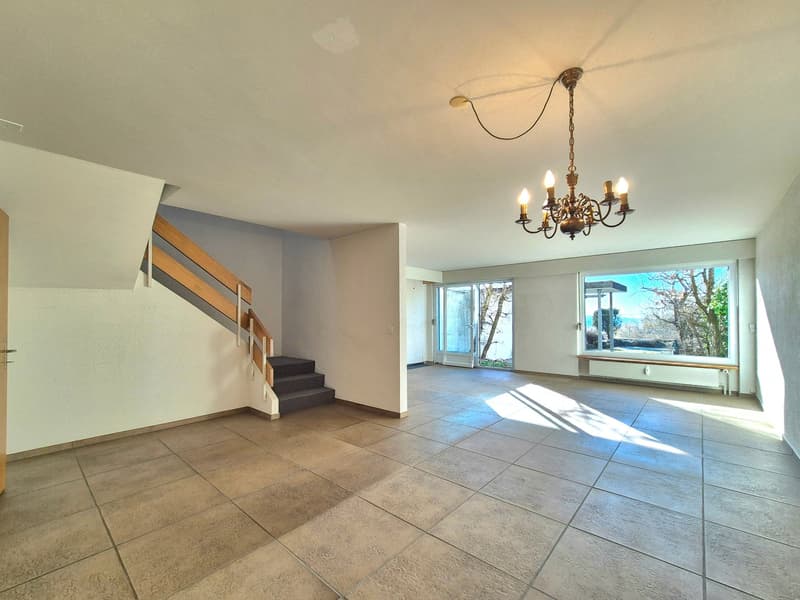 Empty room with staircase, tiled floor, chandelier, glass doors