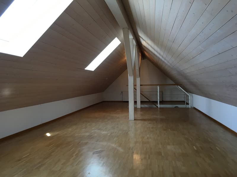 empty attic room, wooden floor, white walls, wooden ceiling, skylights