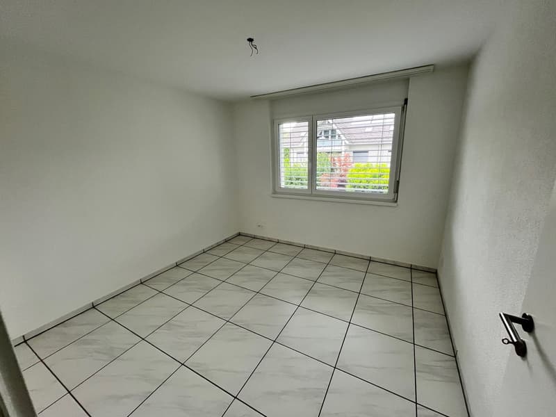 empty room, white tiled floor, white walls, window with blinds, power outlet