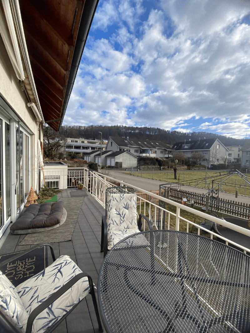 wooden terrace, table and chairs, fence, railings, grass and trees