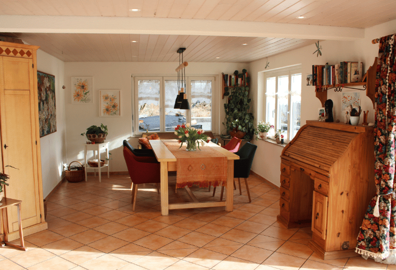dining room, wooden desk, 4 chairs, floor vases, plants, basket, lamps
