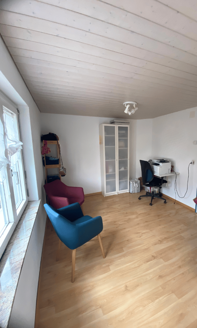 Minimalistic living room, wooden floor, white ceiling, two chairs, cabinet, printer, window