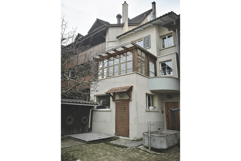 3-storey building, brick, balcony on 2nd floor