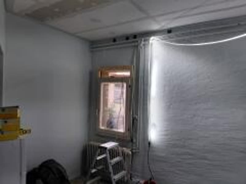 unfinished room, white walls, window, radiator, ladder, cables, power outlet