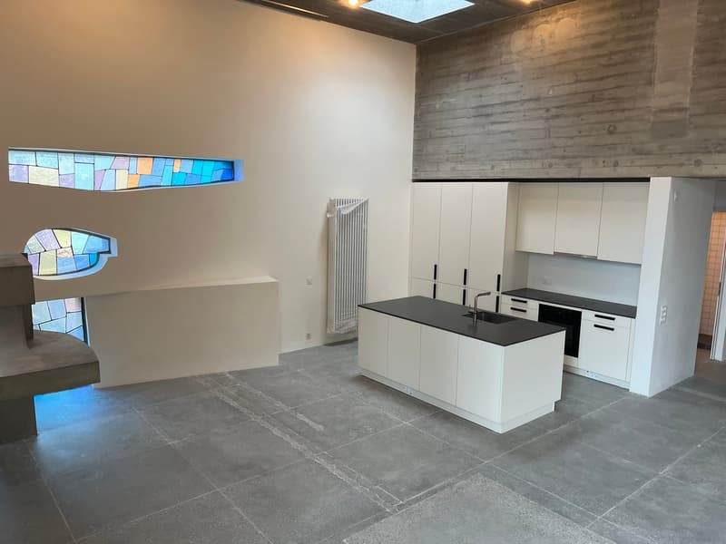 modern open-concept kitchen with white cabinets, granite countertop, black sink, glass window, radiator