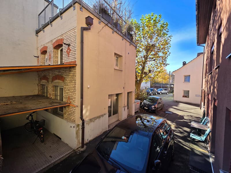 2 story building, balcony on top, attached garage