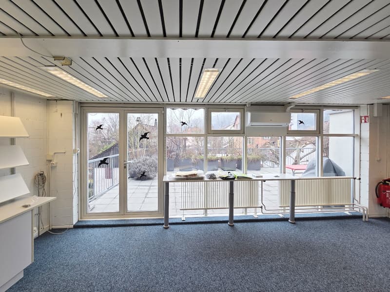 empty room with a large sliding glass door, radiators, overhead lights, carpet, power outlets