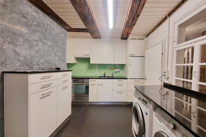 white cabinets, green wall, stove, dishwasher, oven, washing machine